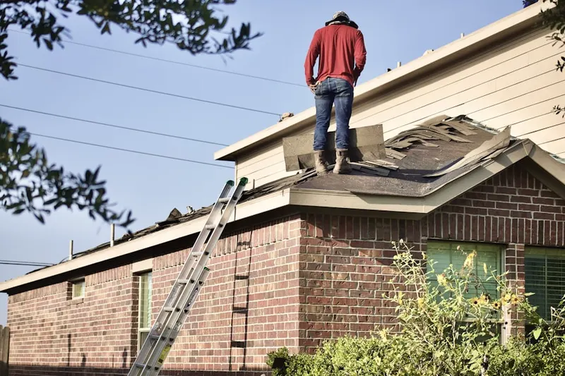 Professional roofer working on a residential roof in Christy Acres